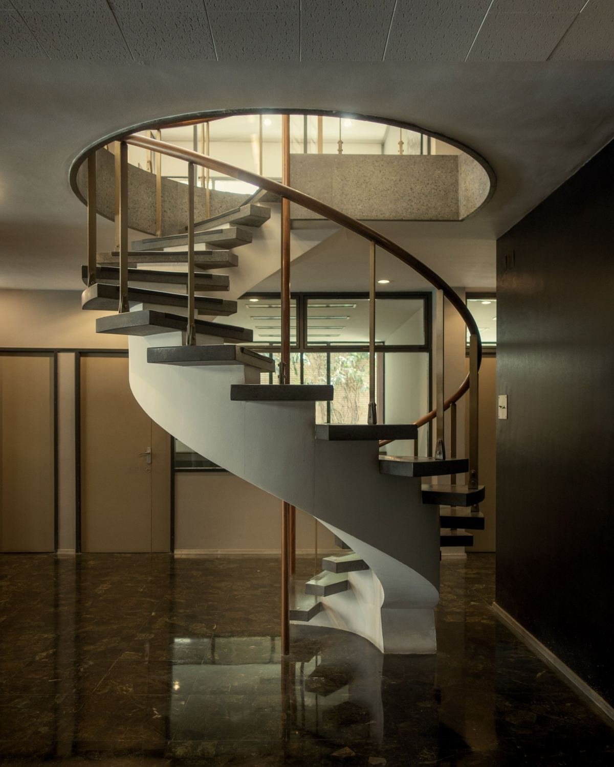 Spiral staircase beneath a circular opening